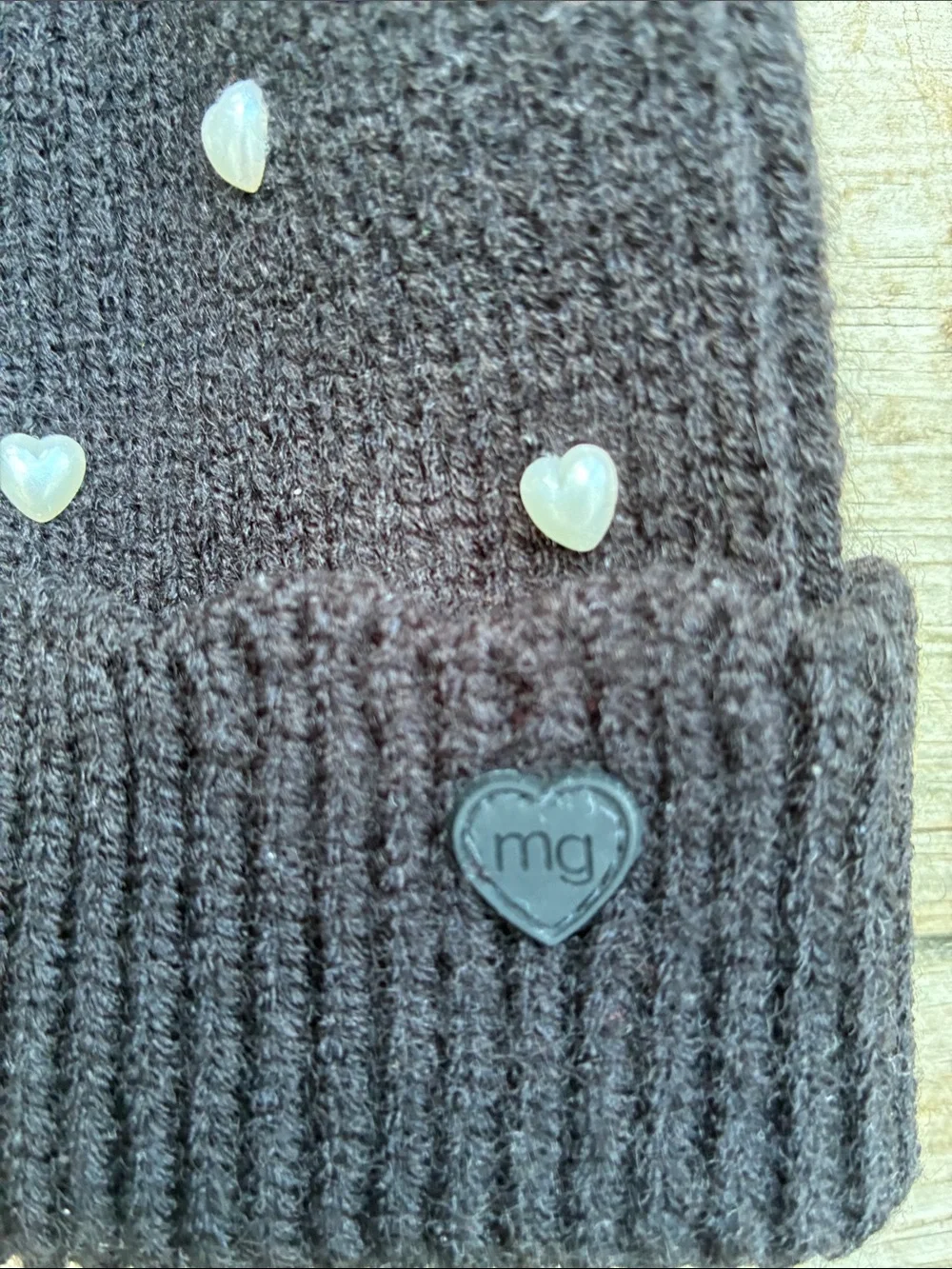 Madden Girl Black Pom-Pom Beanie with Heart Studs